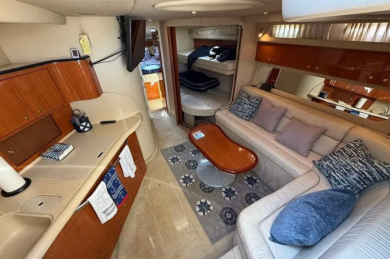 Slide: The Image of Luxurious interior of a 2001 Sea Ray 410 Express Cruiser with elegant seating and wood finishes. - 13