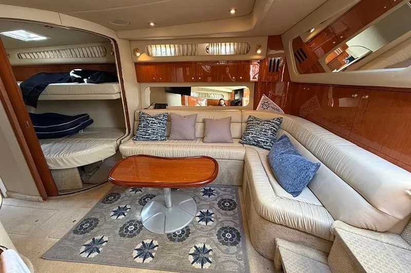 Slide: The Image of Luxurious interior of a 2001 Sea Ray 410 Express Cruiser with plush seating and elegant decor. - 14