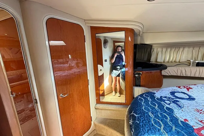 Slide: The Image of Interior of 2001 Sea Ray 410 Express Cruiser with wood paneling and mirror. - 21