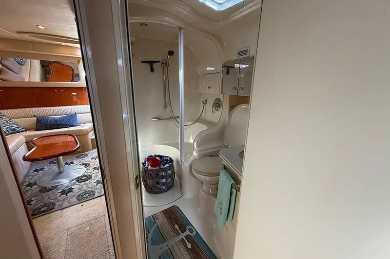 Slide: The Image of Interior of 2001 Sea Ray 410 Express Cruiser showing bathroom and living area. - 24