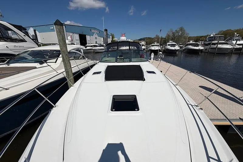 Slide: The Image of 2001 Sea Ray 410 Express Cruiser docked at marina under clear blue sky. - 26