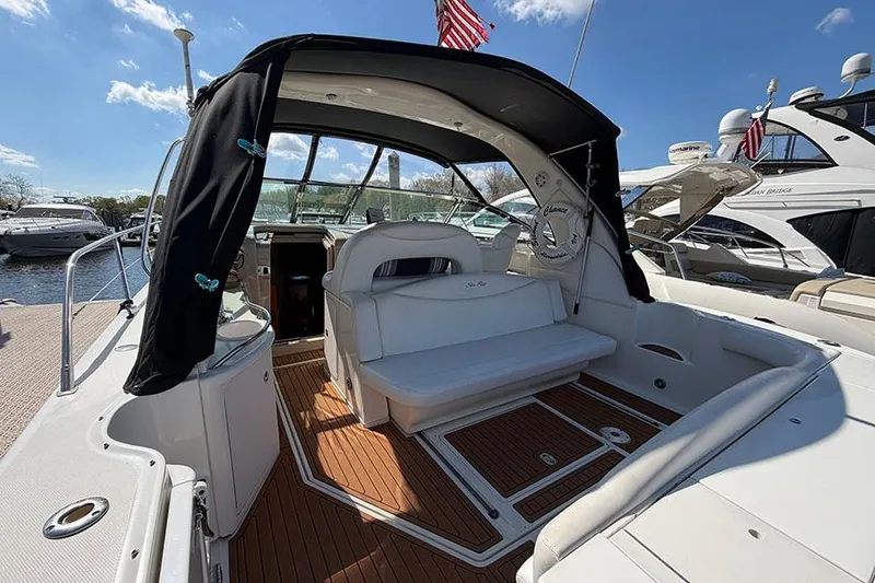 Slide: The Image of 2001 Sea Ray 410 Express Cruiser with teak deck and seating, docked at marina. - 4