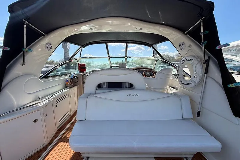 Slide: The Image of 2001 Sea Ray 410 Express Cruiser interior with white seating and helm view. - 6