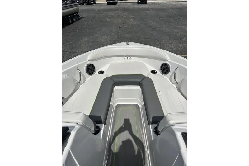 Slide: The Image of 2024 Tahoe 210 S boat interior with seating and speakers, parked on asphalt. - 4