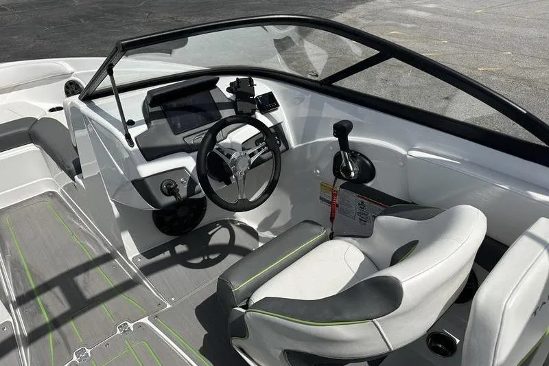 Slide: The Image of 2024 Tahoe 210 S boat interior with modern steering and seating. - 7