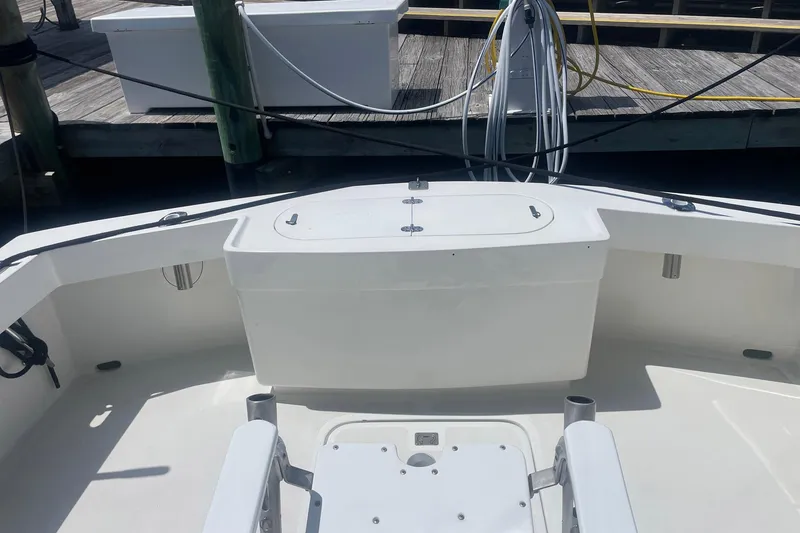 Slide: The Image of 1968 Hatteras 34 Sport Fisherman boat deck with fishing equipment and dock in background. - 11