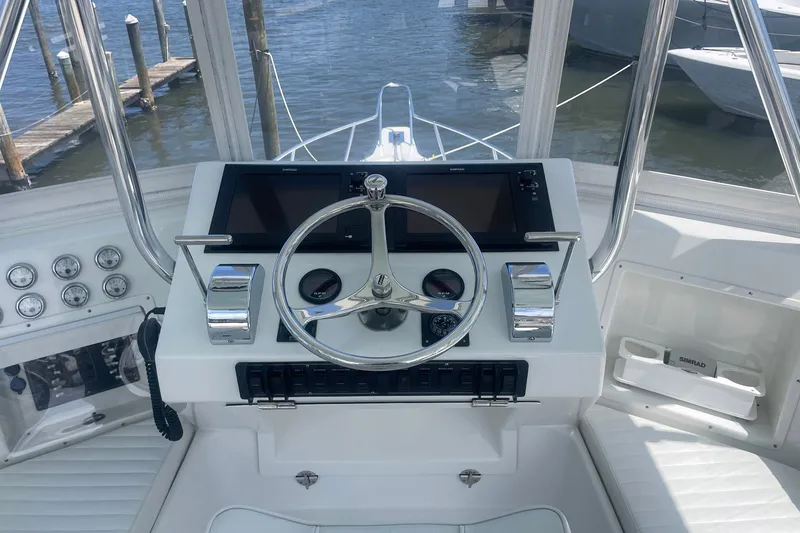 Slide: The Image of 1968 Hatteras 34 Sport Fisherman helm with steering wheel and navigation controls. - 12
