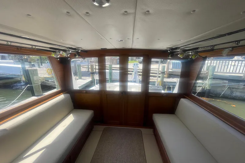 Slide: The Image of Interior of a 1968 Hatteras 34 Sport Fisherman boat with seating and fishing rods. - 20