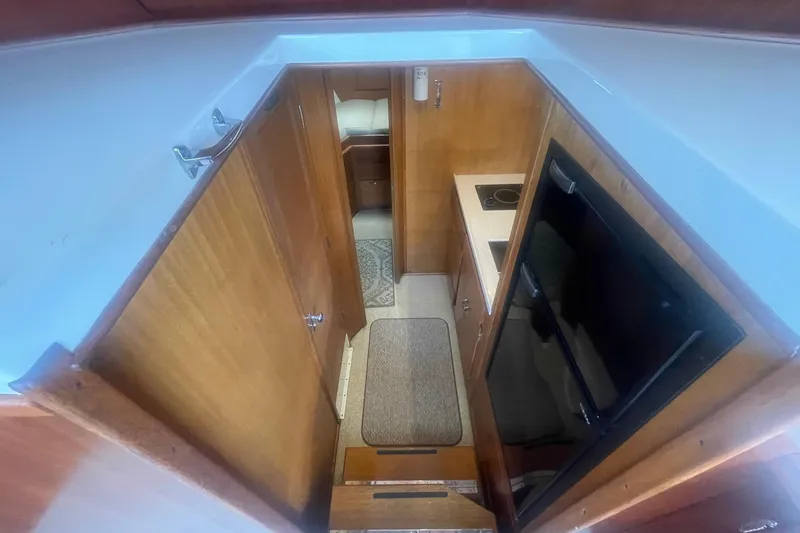 Slide: The Image of Interior view of 1968 Hatteras 34 Sport Fisherman, featuring compact kitchen and cozy cabin space. - 21