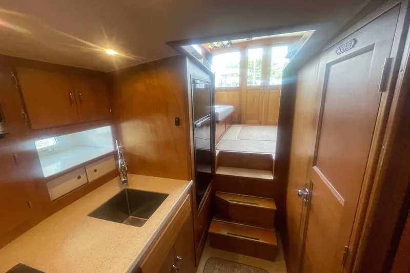Slide: The Image of Interior of 1968 Hatteras 34 Sport Fisherman with wooden cabinetry and stairs. - 23