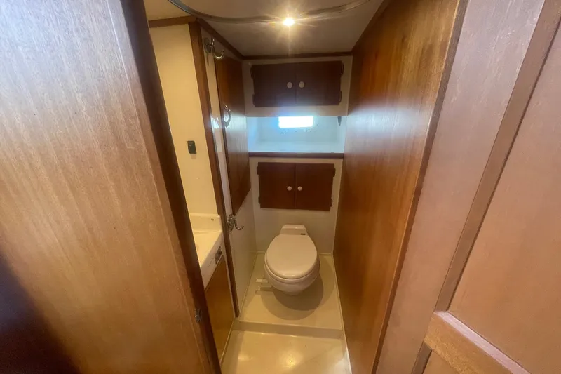 Slide: The Image of 1968 Hatteras 34 Sport Fisherman boat bathroom with wooden cabinetry and compact design. - 24