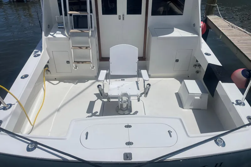 Slide: The Image of 1968 Hatteras 34 Sport Fisherman boat deck with fishing chair and equipment. - 6