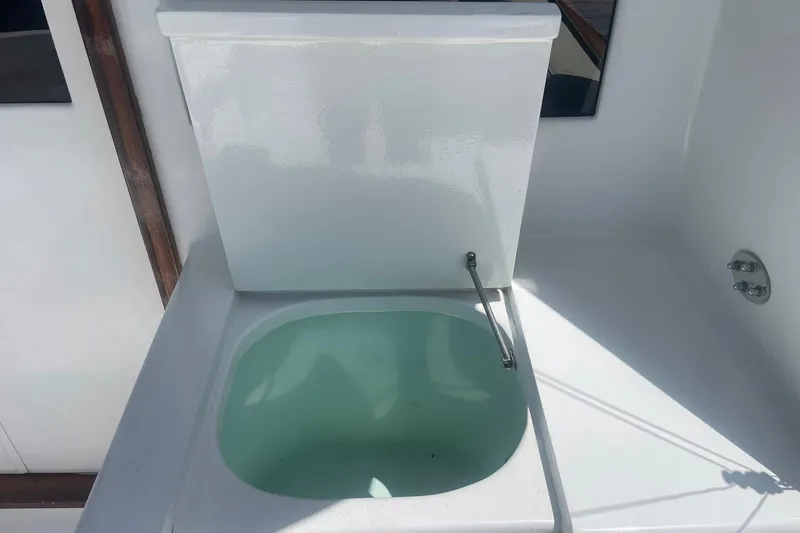 Slide: The Image of Open hatch on 1968 Hatteras 34 Sport Fisherman boat, revealing storage compartment. - 7