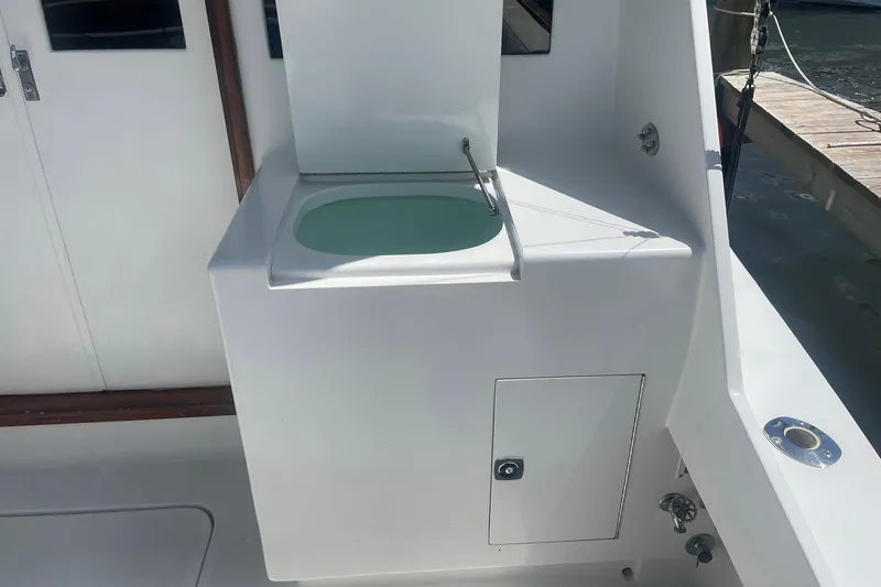 Slide: The Image of 1968 Hatteras 34 Sport Fisherman boat sink and storage area on deck. - 8