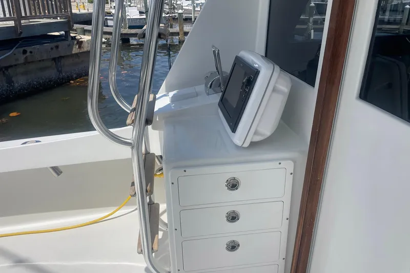 Slide: The Image of 1968 Hatteras 34 Sport Fisherman boat interior with navigation equipment and storage drawers. - 9