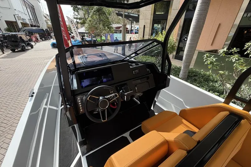 Slide: The Image of Interior view of Iron 907 boat, 2025 model, featuring modern steering and orange seats. - 8