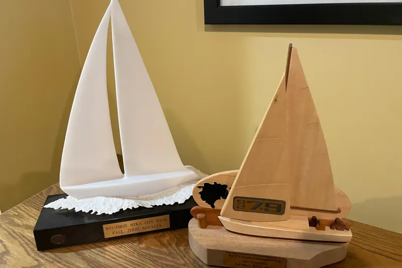 Slide: The Image of Trophies featuring sailboat designs, celebrating sailing achievements, including S2 7.9 Grand Slam model. - 4