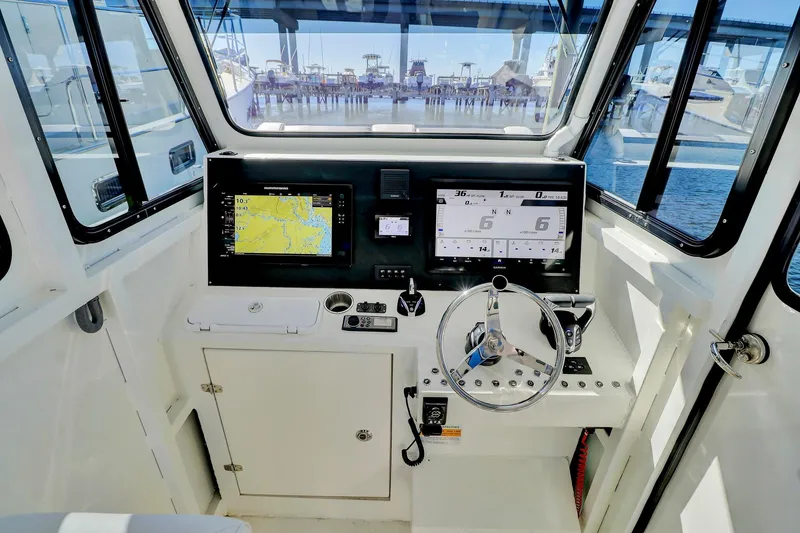 Slide: The Image of Cockpit of 2024 Nerowalker 35 boat with navigation screens and steering wheel. - 11