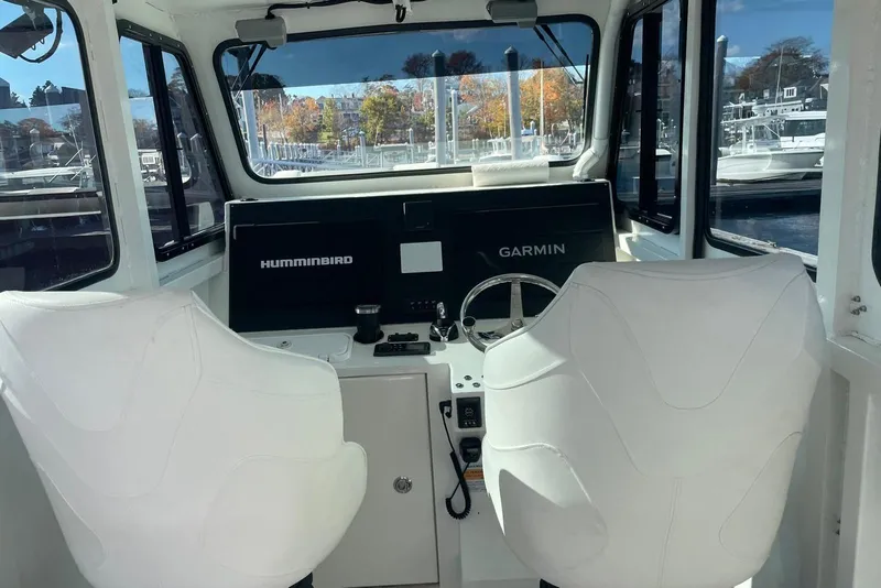 Slide: The Image of Interior of 2024 Nerowalker 35 boat with dual white seats and navigation equipment. - 15