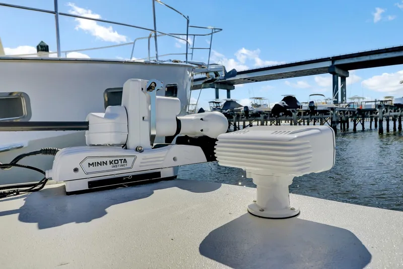 Slide: The Image of Boat with Minn Kota Instinct motor, Nerowalker 35, 2024 model, docked near a bridge. - 19