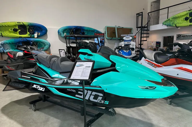 The Image of 2026 Kawasaki Jetski Ultra 310LX-S displayed in a showroom with kayaks. - 0