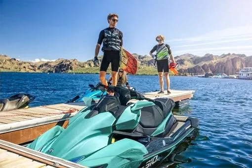 Slide: The Image of 2026 Kawasaki Jetski Ultra 310LX-S on a sunny lake with two people on a dock. - 3