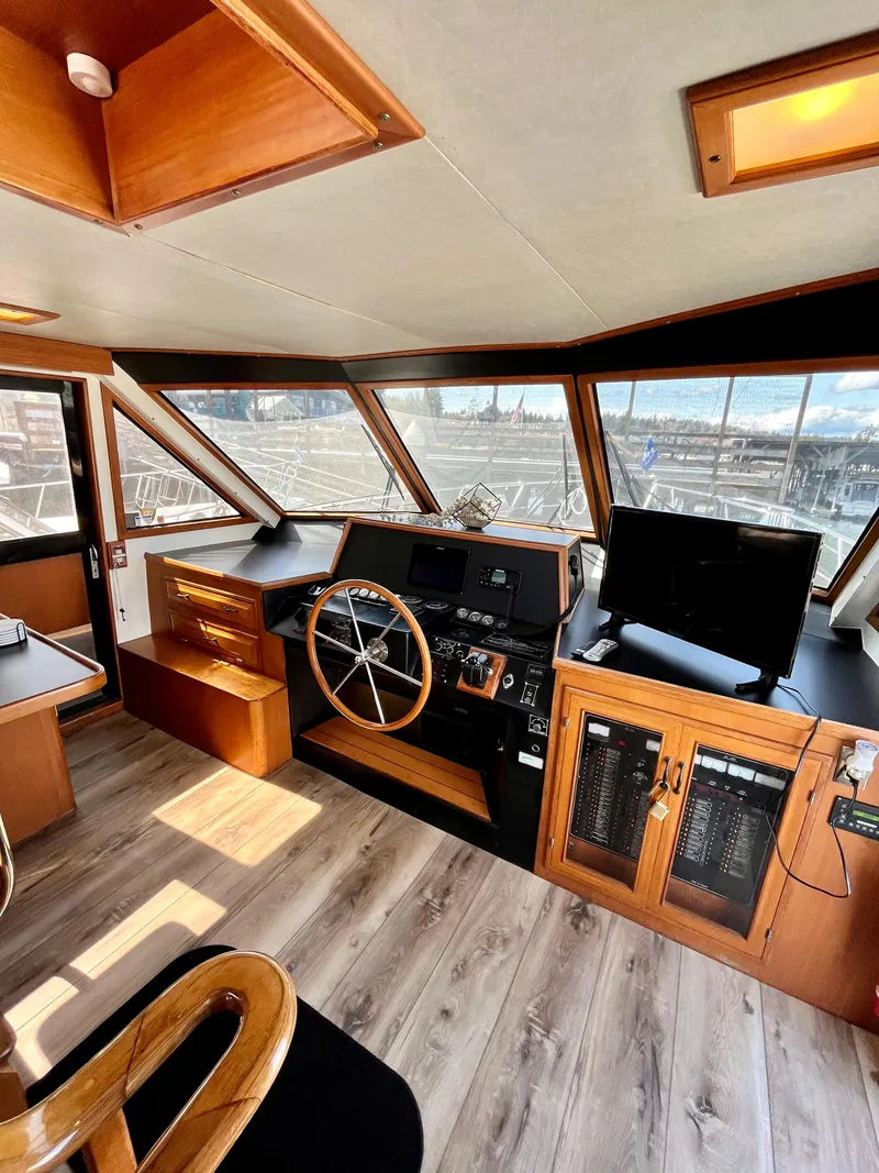 Slide: The Image of 1989 Angel Pilothouse interior with steering wheel, control panel, and panoramic windows. - 11