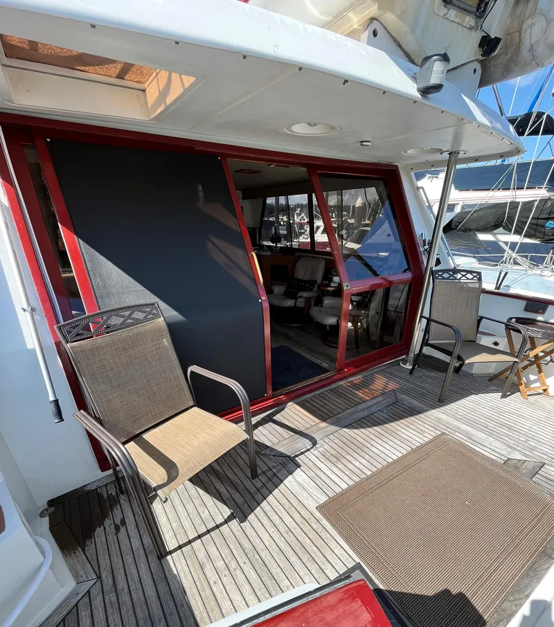 Slide: The Image of 1989 Angel Pilothouse boat with outdoor seating and sliding glass doors. - 2