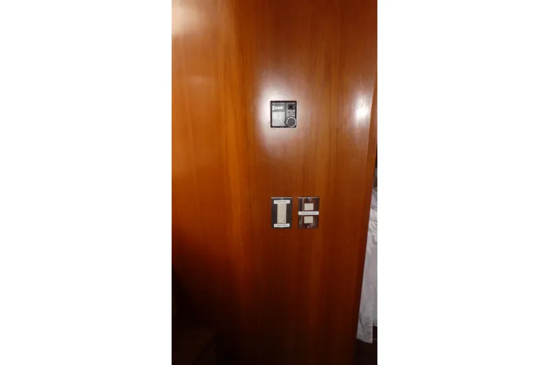 Slide: The Image of Wooden panel with control switches on 1989 Angel Pilothouse boat interior. - 20