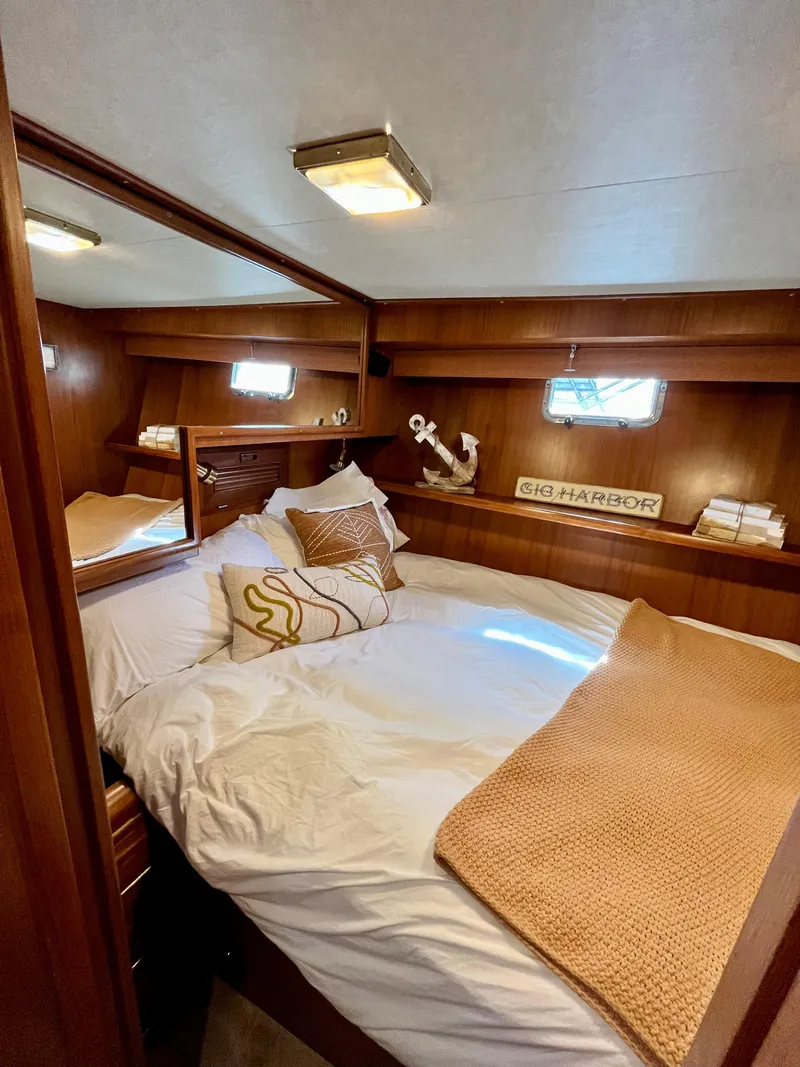 Slide: The Image of Cozy bedroom in a 1989 Angel Pilothouse boat with nautical decor. - 22
