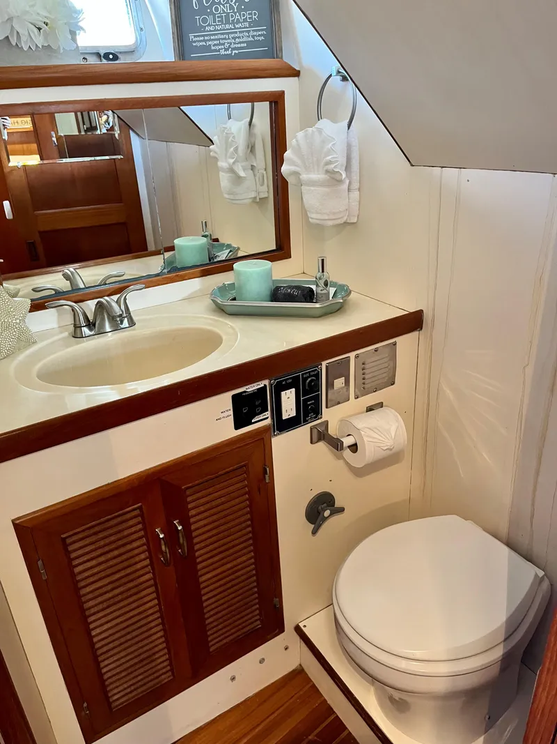 Slide: The Image of 1989 Angel Pilothouse bathroom with sink, mirror, and toilet. - 24