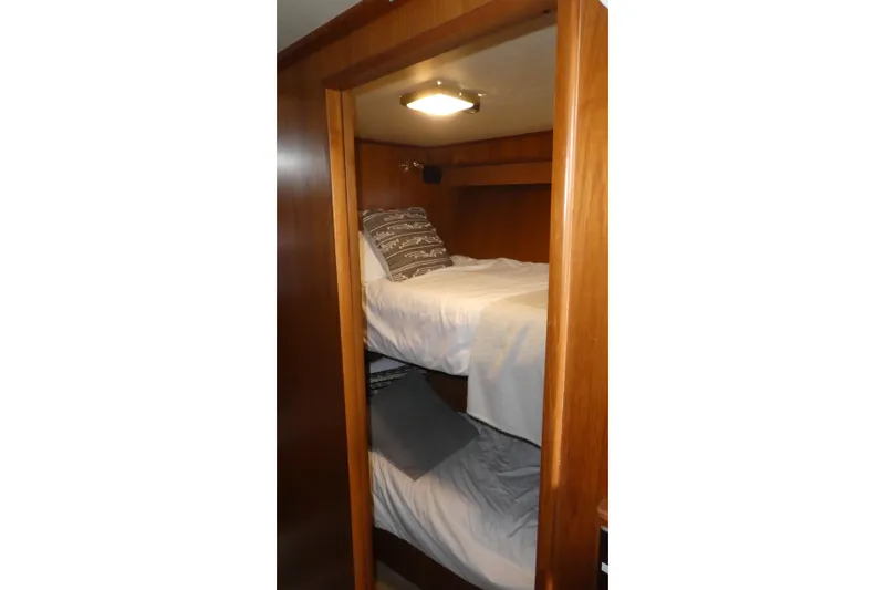 Slide: The Image of Bunk beds in 1989 Angel Pilothouse, featuring wooden interior and cozy bedding. - 25