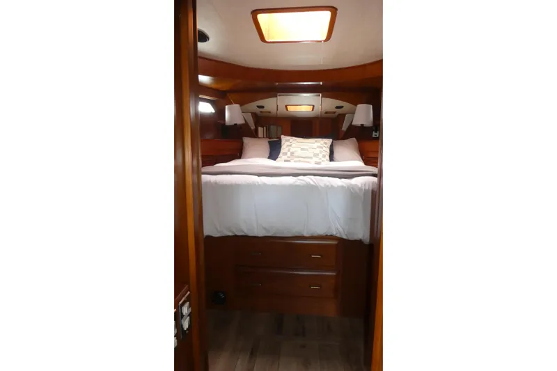 Slide: The Image of Cozy cabin interior of 1989 Angel Pilothouse yacht with wooden furnishings and comfortable bedding. - 27