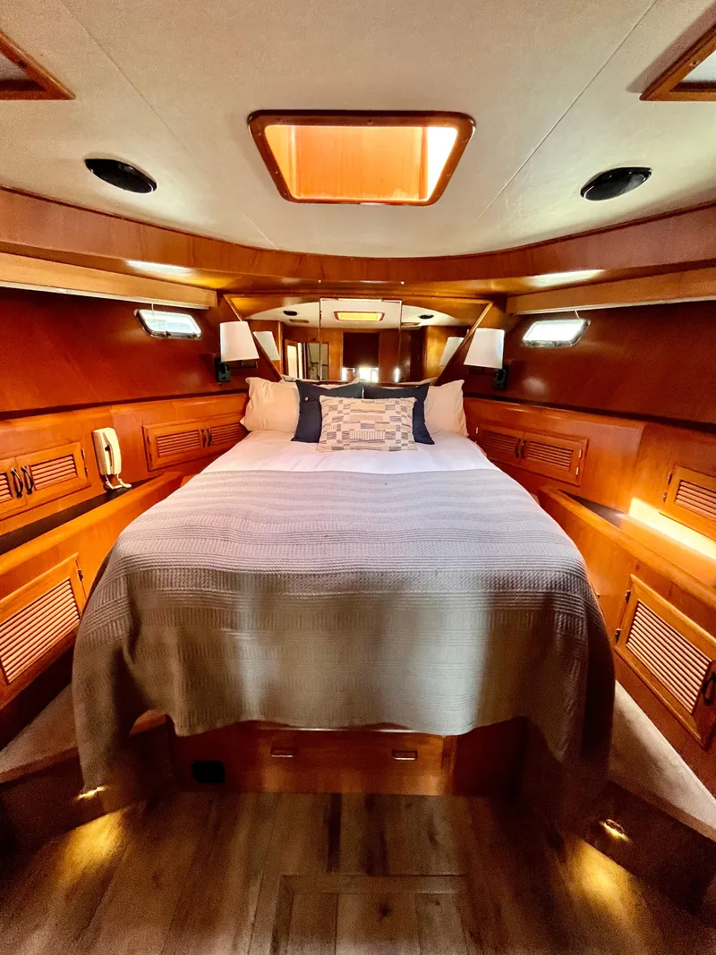 Slide: The Image of Luxurious bedroom in a 1989 Angel Pilothouse yacht with wooden interior. - 28