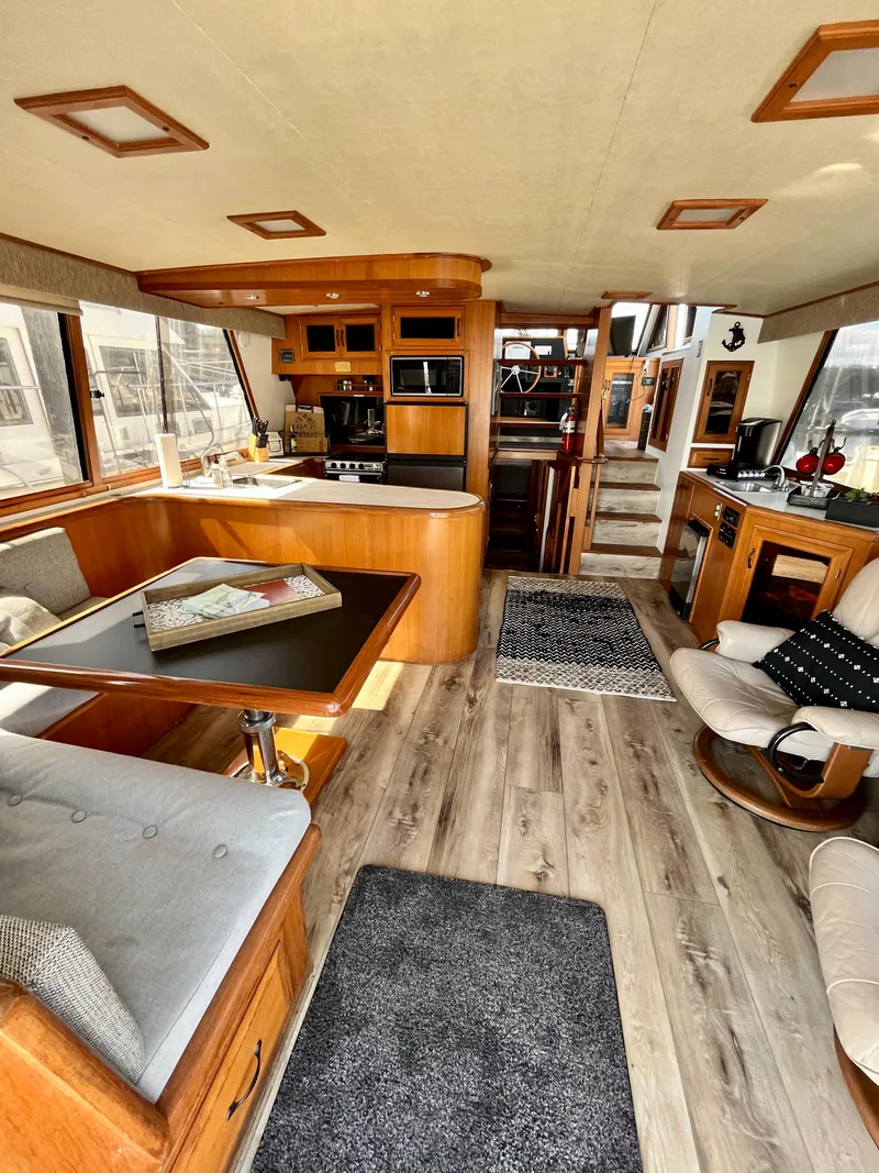Slide: The Image of 1989 Angel Pilothouse interior with modern kitchen, dining area, and cozy seating. - 3