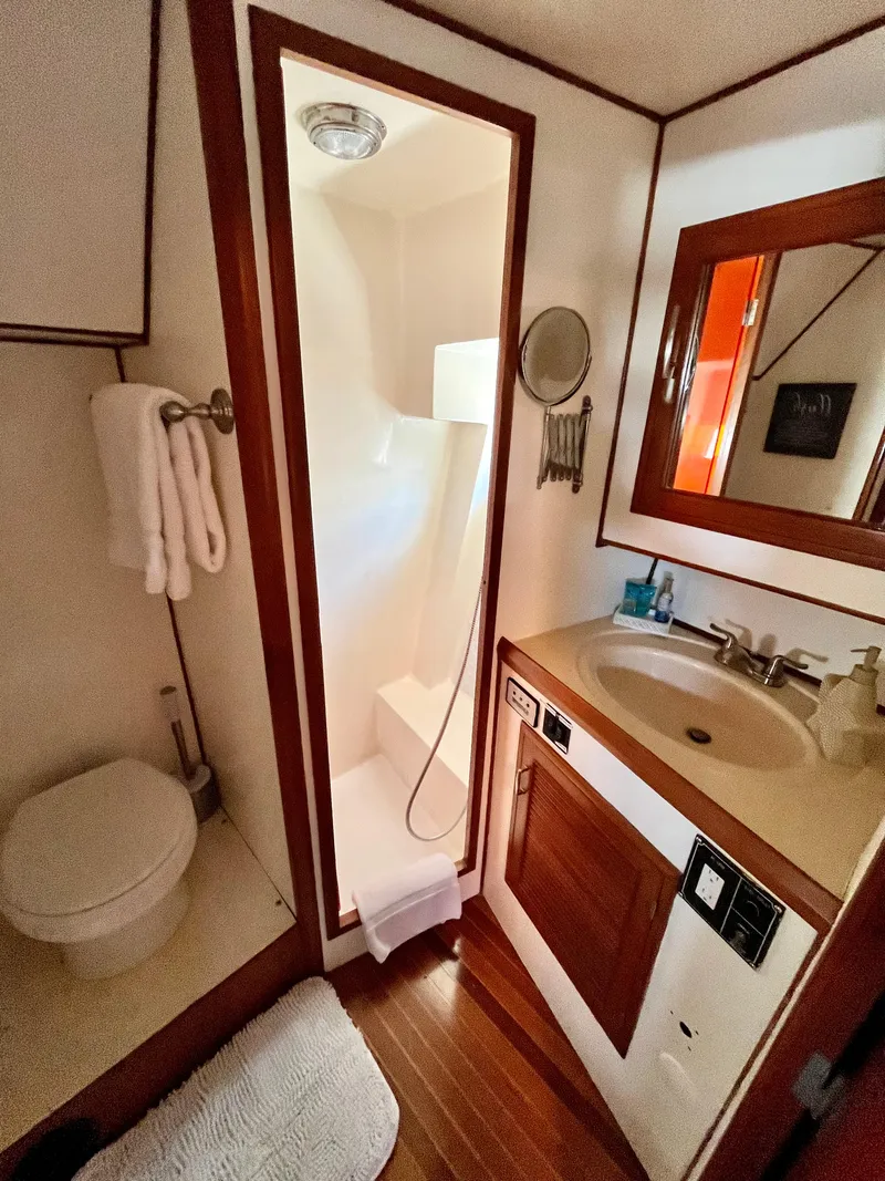 Slide: The Image of 1989 Angel Pilothouse bathroom with shower, sink, and toilet. - 30