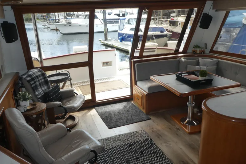 Slide: The Image of Luxurious interior of 1989 Angel Pilothouse yacht with cozy seating and waterfront view. - 33