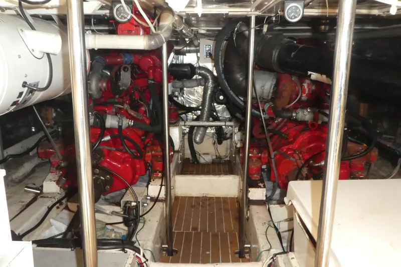 Slide: The Image of Engine room of a 1989 Angel Pilothouse boat with red machinery and pipes. - 35