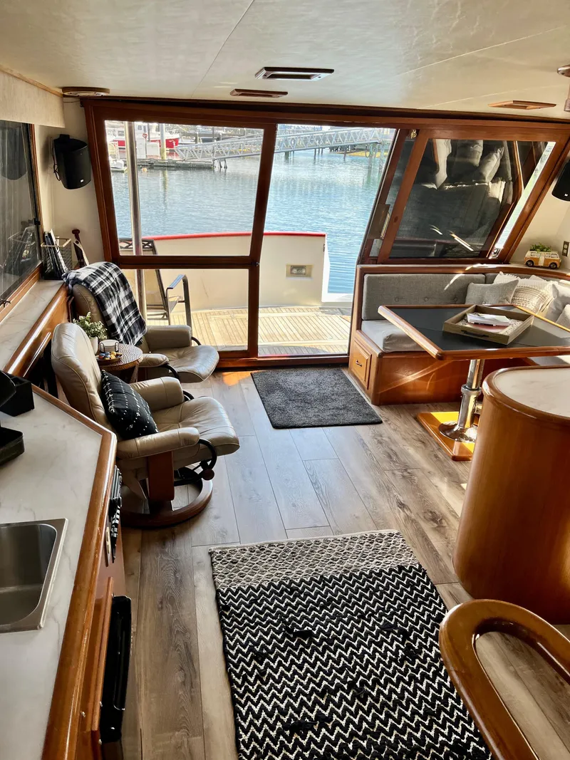 Slide: The Image of 1989 Angel Pilothouse interior with waterfront view, cozy seating, and modern amenities. - 4