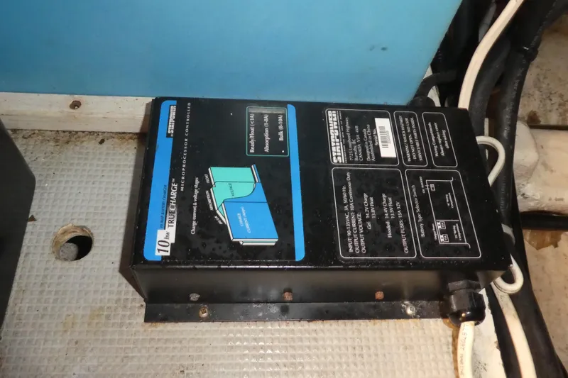 Slide: The Image of Battery charger in 1989 Angel Pilothouse boat, mounted on textured surface. - 43