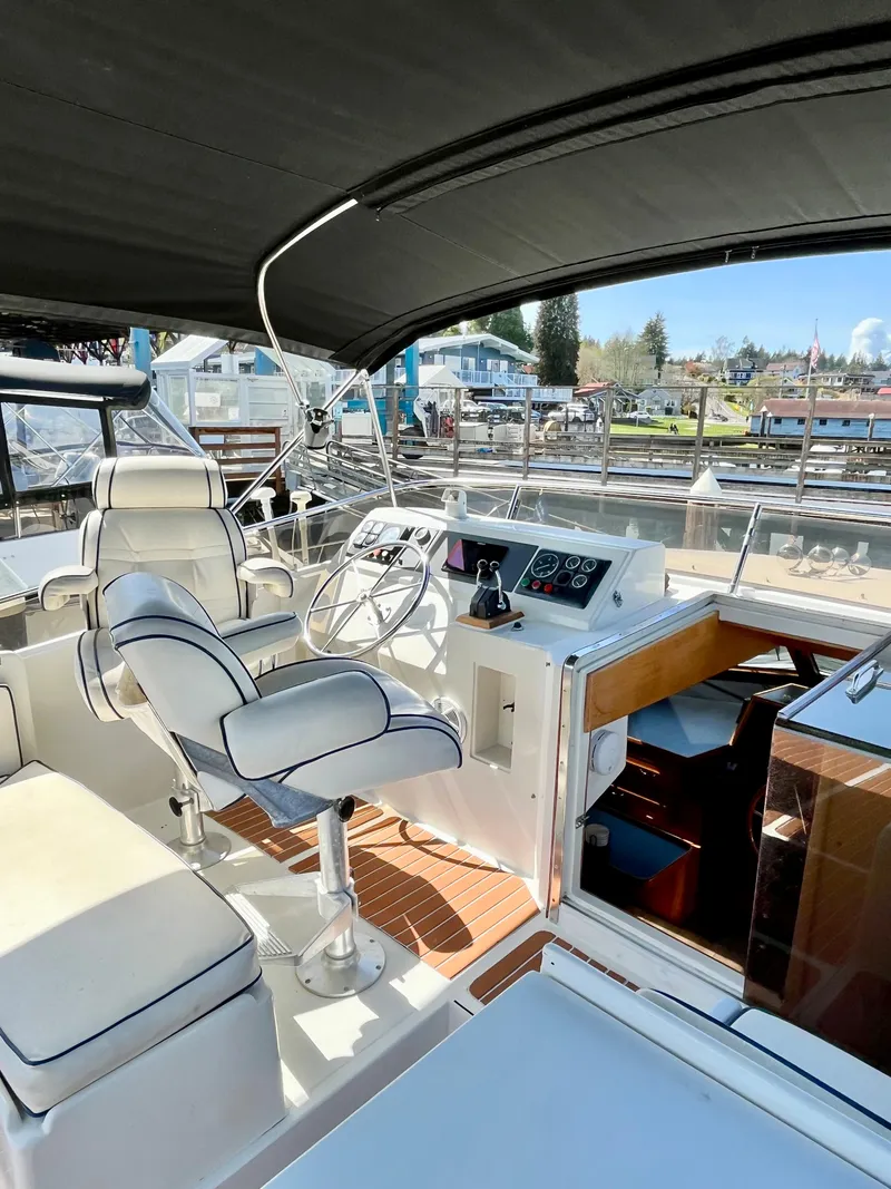Slide: The Image of 1989 Angel Pilothouse boat interior with helm station and seating. - 45