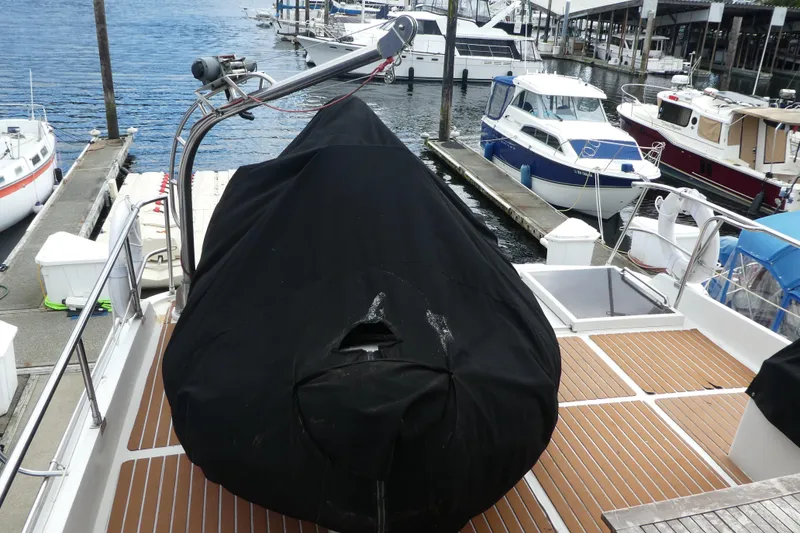 Slide: The Image of Covered boat on deck of 1989 Angel Pilothouse, docked at marina with surrounding vessels. - 50