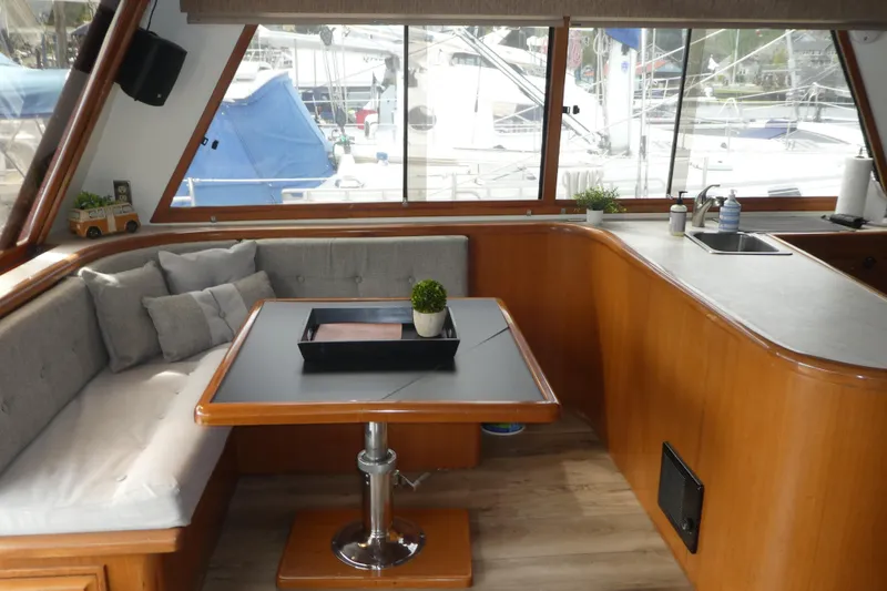 Slide: The Image of Interior of 1989 Angel Pilothouse yacht with cozy seating and wooden table. - 8