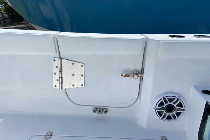 Slide: The Image of 2026 Sportsman Heritage 321 Center Console boat interior with speaker and storage compartment. - 12
