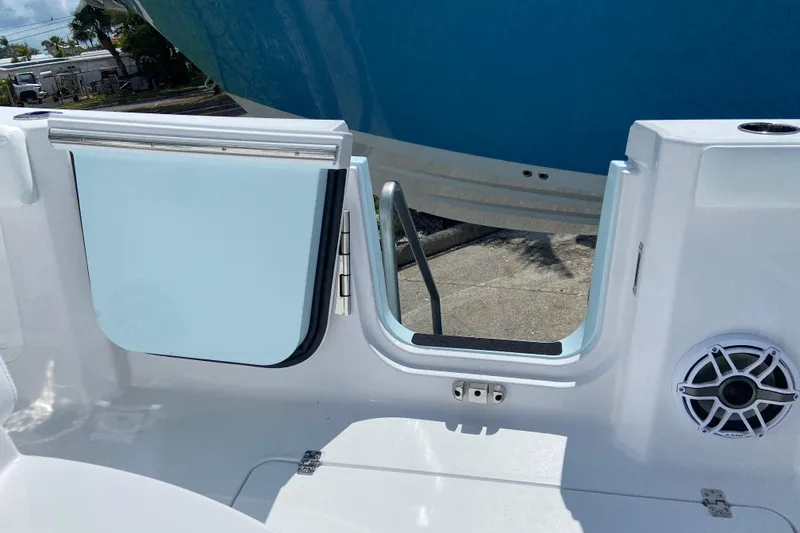 Slide: The Image of 2026 Sportsman Heritage 321 Center Console boat with open side door and speaker detail. - 13