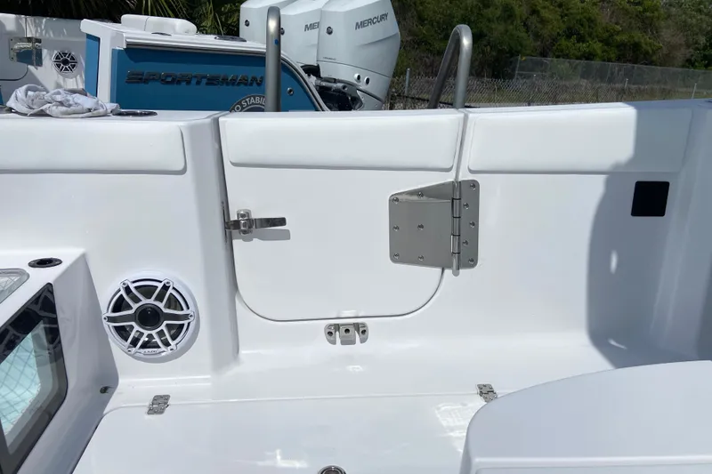 Slide: The Image of 2026 Sportsman Heritage 321 Center Console boat interior with speaker and hatch details. - 14