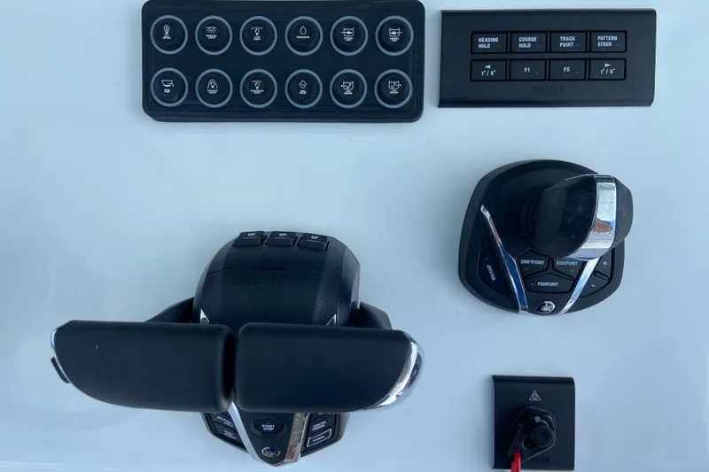 Slide: The Image of Control panel of 2026 Sportsman Heritage 321 Center Console boat with joystick and buttons. - 18