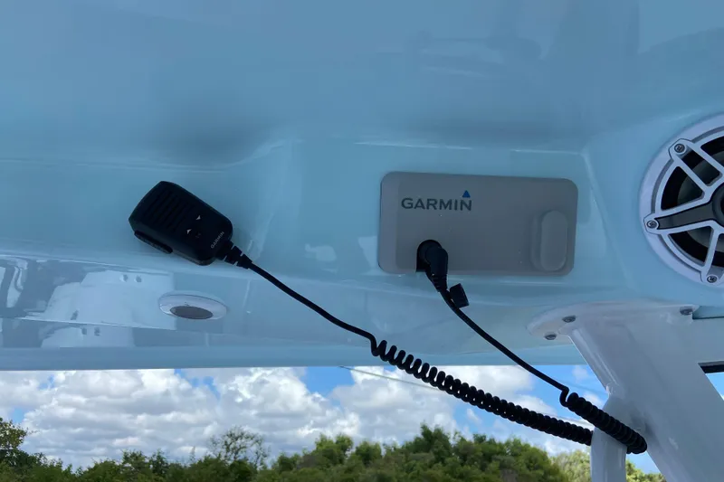 Slide: The Image of 2026 Sportsman Heritage 321 Center Console with Garmin device and speaker under clear sky. - 21