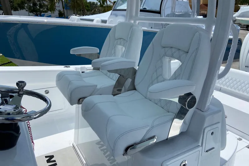 Slide: The Image of 2026 Sportsman Heritage 321 Center Console boat with luxurious white seating and modern design. - 23