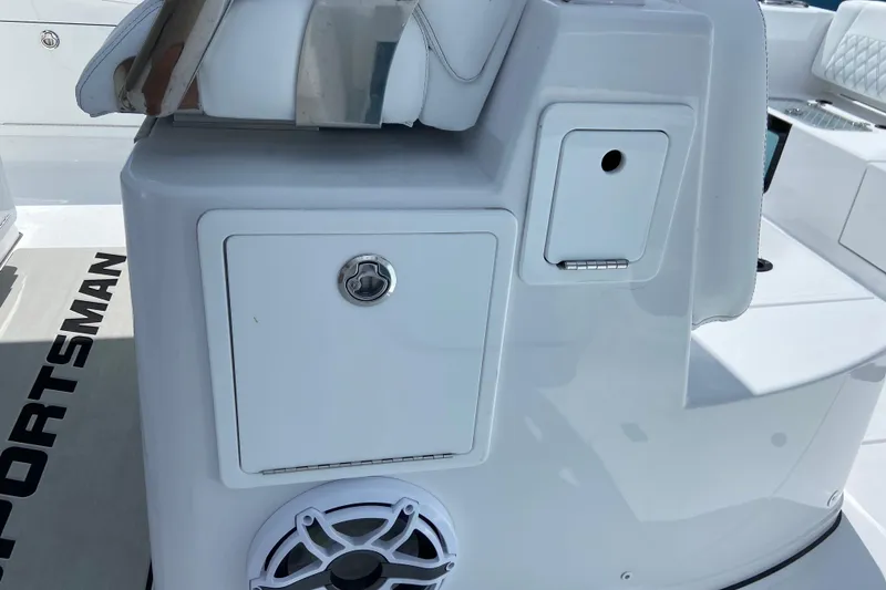 Slide: The Image of 2026 Sportsman Heritage 321 Center Console boat interior with storage compartments and speaker. - 24